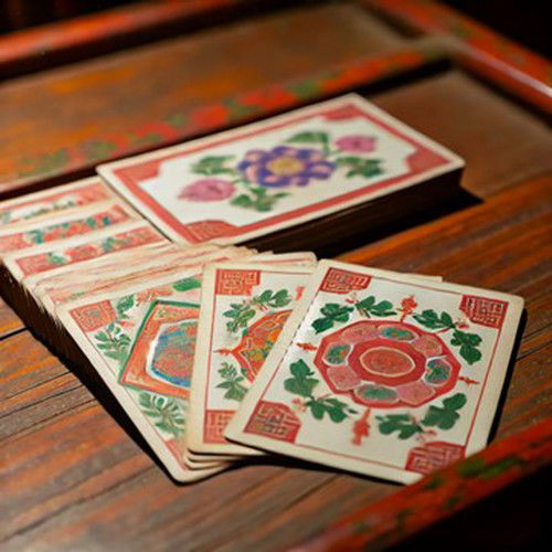 A recreation of early Chinese playing cards from the Tang dynasty, showcasing ornate, hand-painted designs on paper.