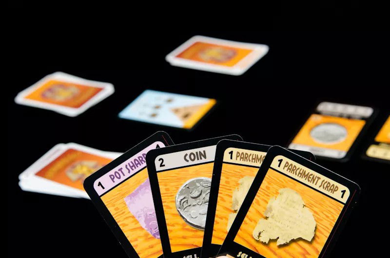 A Player gathering Artifact Cards in hand to sell afterwards to the Museum